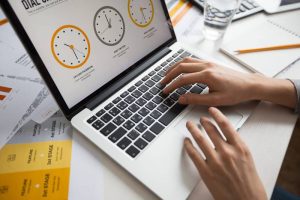 Close-up of hands typing on a laptop showing DID monitoring analytics