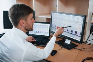 A call center agent with a headset working on a laptop with SIP monitoring software