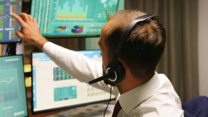 A hotel receptionist on the phone, relying on a MiRTA PBX system